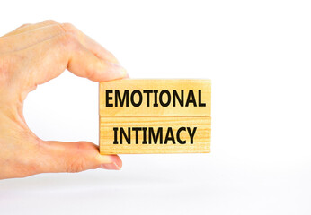 Emotional intimacy symbol. Concept words Emotional intimacy on beautiful wooden blocks. Beautiful white table white background. Psychologist hand. Psychology emotional intimacy concept. Copy space.