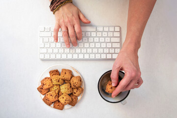 Coffee break with biscuits while working on a computer or for leisure