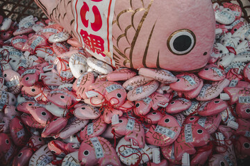A lots of pink japanese fishes figures or toys from a shrine Omikuji