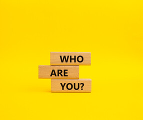 Who are You symbol. Concept words Who are You on wooden blocks. Beautiful yellow background. Business and Who are You concept. Copy space.