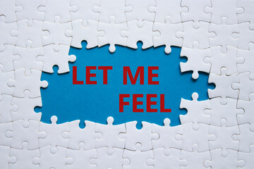 Feel symbol. Concept words Let me feel on white puzzle. Beautiful blue background. Psychology and let me feel concept. Copy space.