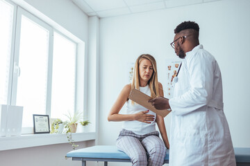A woman in consultation with a doctor with abdominal pain. It is a painful menstrual period or bladder. And ectopic pregnancy. Immediate treatment immediately - obrazy, fototapety, plakaty