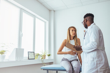 A woman in consultation with a doctor with abdominal pain. It is a painful menstrual period or...