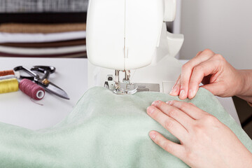 Sewing machine, stitching fabrics, needle in a round plan