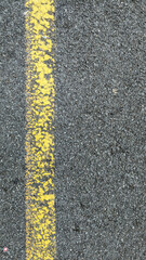 Fototapeta premium Yellow lines on asphalt
