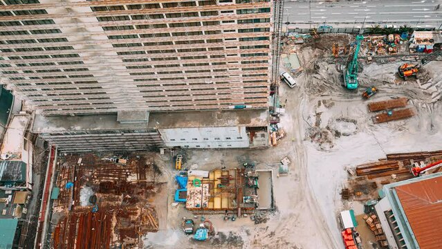 Elevated View timelapse with construction site area. Development Multistorey Residential Building. excavator and other machinery with Workers are engaged in repairing development on construction site