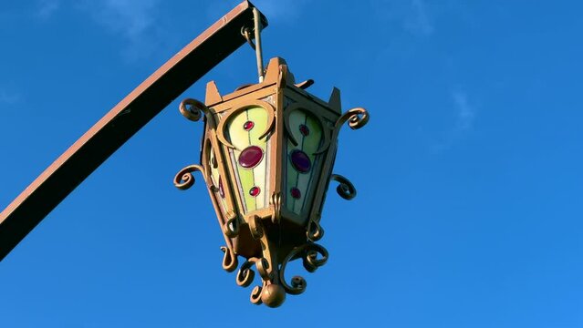 Beautiful street lamp in vintage style against blue sky.