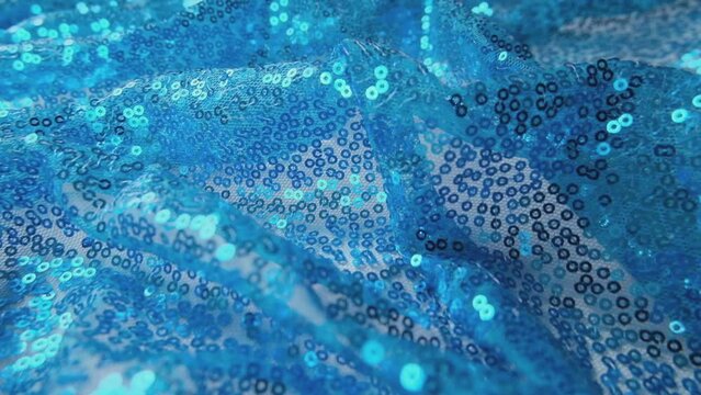 Blue sequins background - abstract festive backdrop for Holiday and party banner. Glamor shiny background with sequin texture.