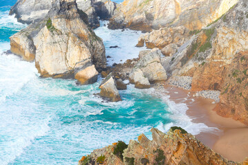 Atlantic ocean coast in Portugal. Scenic view of coastline with huge boulders at the Praia da Ursa...