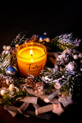 christmas decoration with candles and decorations. burning candle in dark like a heart. Selective focus, black background. Christmas time. Celebrating Christmas in church. Festive church decoration. 