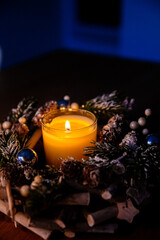 christmas decoration with candles and decorations. burning candle in dark like a heart. Selective...