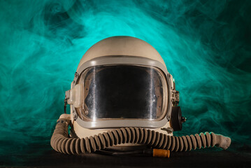 Pressure helmet on the table front view in the blue smoke background. Space helmet concept.