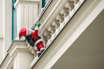 Weihnachtsdekoration , Weihnachtsmann klettert am Balkon hoch