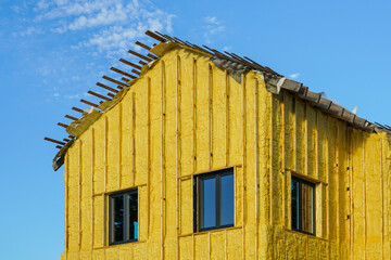 The facade of the residential house sprayed with a layer of polyurethane thermal insulation foam