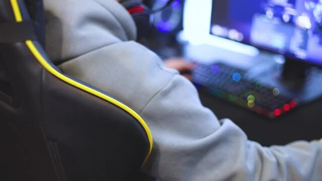 Cyber sport e-sports tournament, team of professional players, gamers playing online championship in competitive moba, strategy fps game in a cyber games arena club, person in a chair with pc
