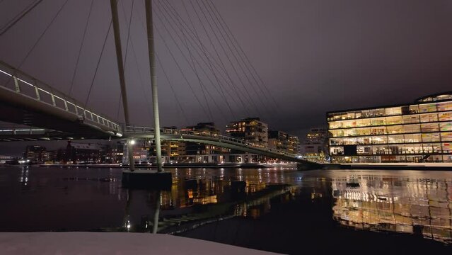 Walking along the river in Drammen city, Norway.The river is called Drammenselva, and the bridge is called Ypsilon.  The city's library is located on the right side of the river.