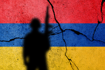 Armenia and Azerbaijan conflict in Nagorno Karabakh. Armenian flag on the cracked concrete wall with soldier