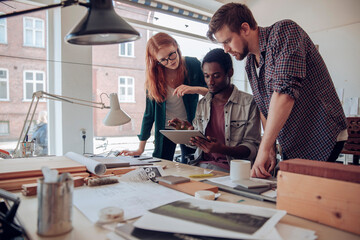 Diverse group of designers working on project in office