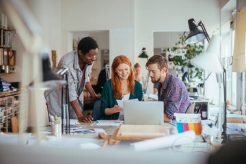 Diverse group of designers working on project in office