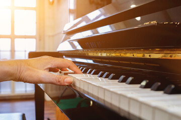 Soft Focus and Blur,The pianist is fixing and adjusting the sound of the piano correctly and precisely so that the practice and performance of the piano will be melodious and without glitches. - obrazy, fototapety, plakaty