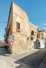 Urban street with typical mediterranean houses on the island Favignana in Sicily.