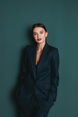 Fashionable confident woman wearing elegant green suit