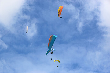 Paragliders flying in a blue sky