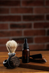 Bottle essential oil for beard men on background dark brick, spa barbershop cosmetics for man