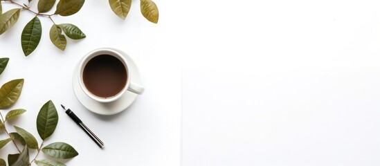 Top view notepad and cup of coffee on white wooden background
