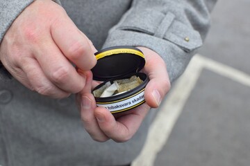 A box of snus pads is a substitute for smokeless cigarettes. Swedish nicotine pouche  close-up. 