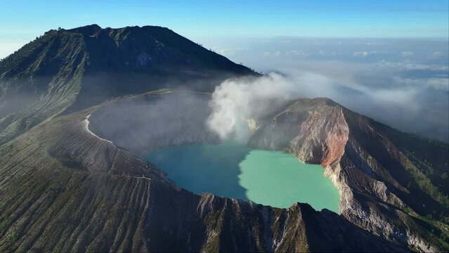 Aerial view drone orbit around to reveal Kawah Ijen volcano crater, Indonesia