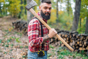 A close-up of the hipster woodsman with an axe casually slung over his shoulder.