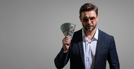 Successful business man counting money. Handsome middle age man holding bunch of 100 dollar...