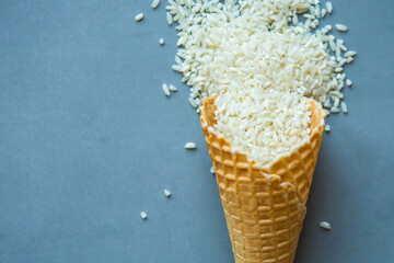 Raw white rice in waffle cone. Flat lay, top view, copy space, minimal