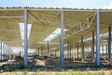 The structural steel structure of a new commercial building on reinforced concrete supports