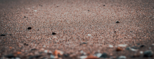 Close up sand beach background concept photo. Colorful small sea stones on the beach.