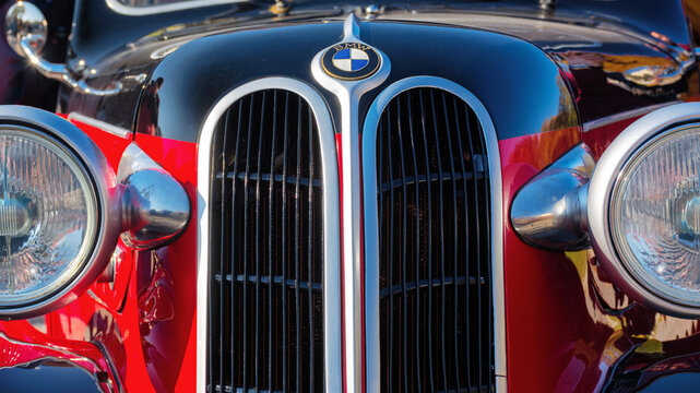 uzhgorod, ukraine - 31 oct 2021: front close-up of a red bmw 321 oldtimer with black hood. sunny outdoor in autumn park