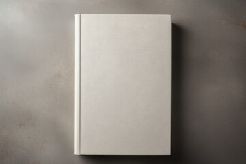 A blank hardcover book mockup with a matte finish, lying flat on a textured linen surface.