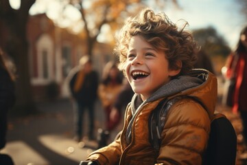 Child's Infectious Laughter: A young boy's delightful chuckle embodies the pure joy of childhood in autumn. - obrazy, fototapety, plakaty
