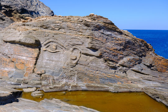 God Aeolus carved on the rock at Kavalourko Beach