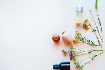 Flat lay photo with cosmetic bottles and herbs on white background, copy space. Natural cosmetics...