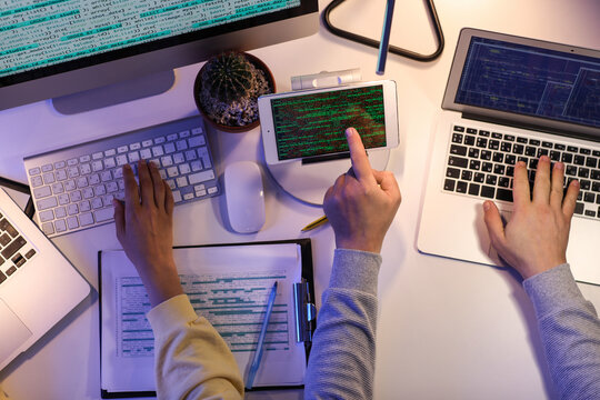 Programmers working in office at night, top view