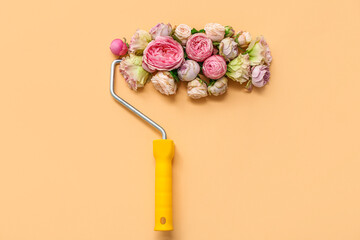 Composition with paint roller and beautiful flowers on color background