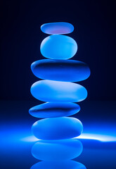 zen stones on blue neon background.Minimal creative nature concept