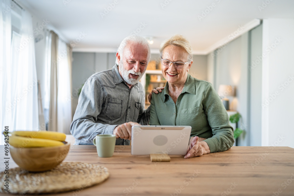 Wall mural senior couple man woman husband and wife use digital tablet video call