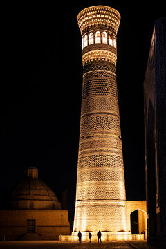 uzbek minaret at night with three people