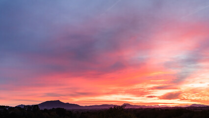 Amazing pink sunset in Arcangues with the Pyrenees and the Rhune Mountain. Basque Country of France.