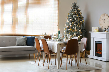 Dining table with beautiful setting in living room decorated for Christmas celebration