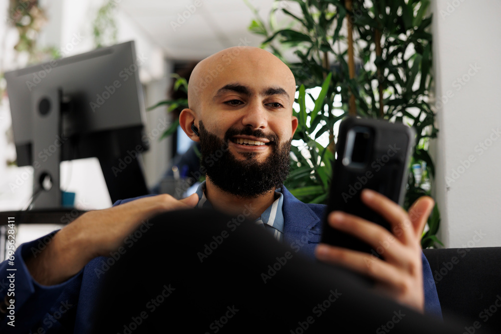 Poster smiling executive manager discussing business goals with coworker in video call on smartphone. start