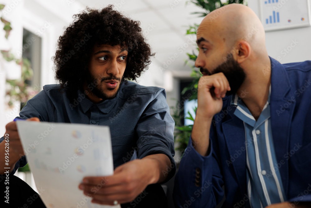Poster executive manager and colleague brainstorming while analyzing report together in business office. fi